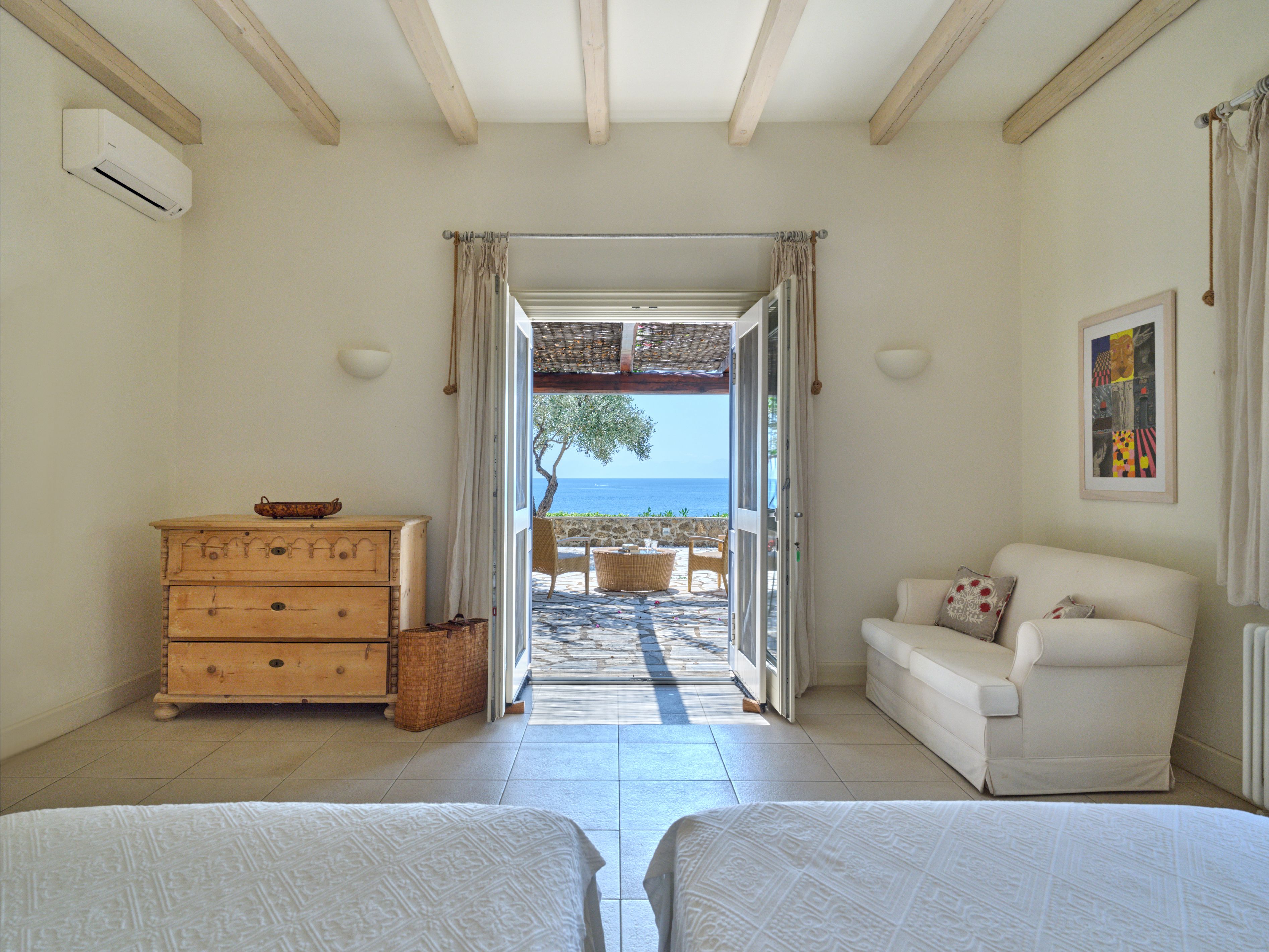 The sofa bed in the second master suite, doors open to the terrace