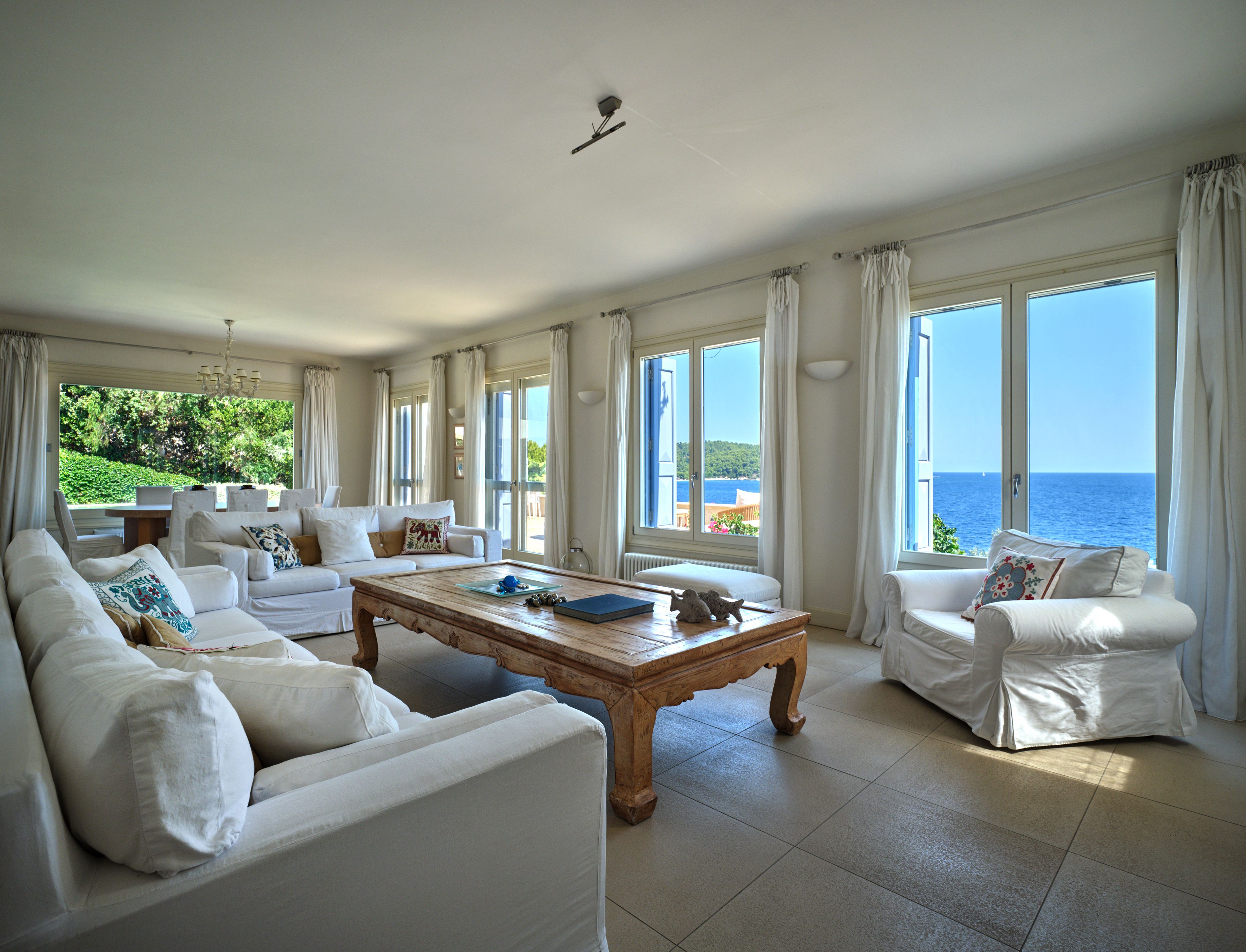 The living room, with sofas and windows onto the sea