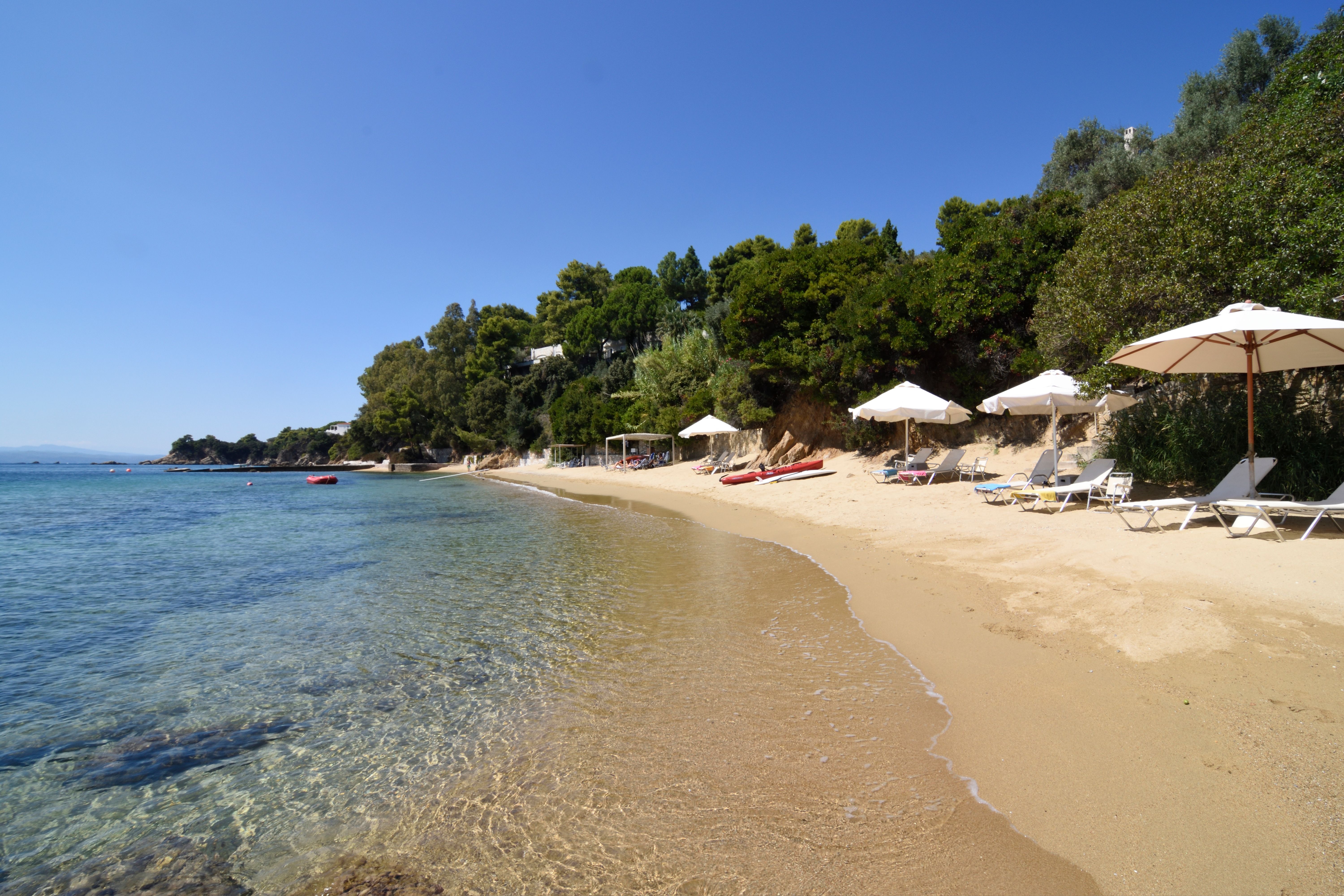 The sweep of golden sand and shallow, clear water along the beach