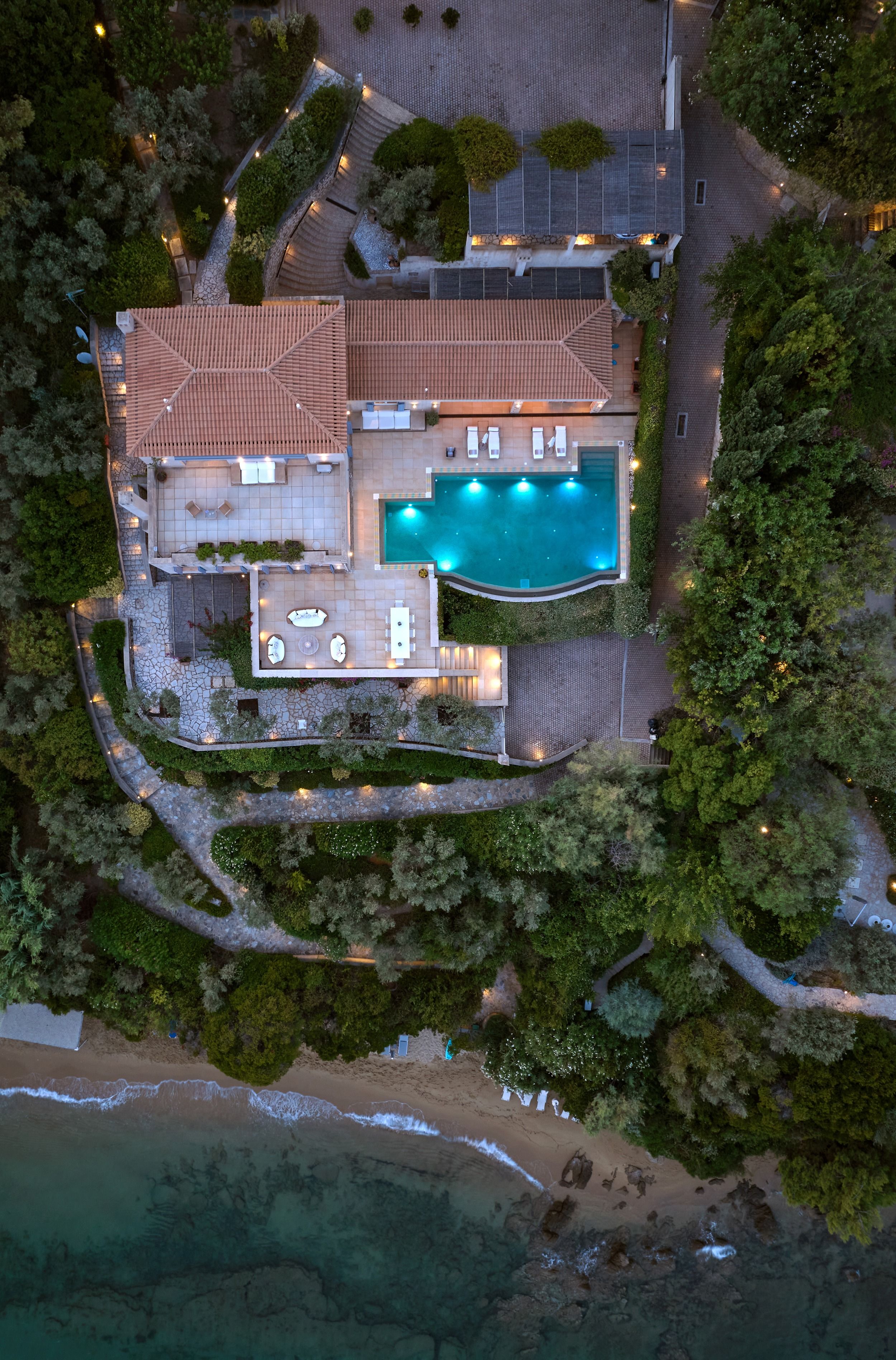 Villa Goldie at dusk from above, the pool lit up