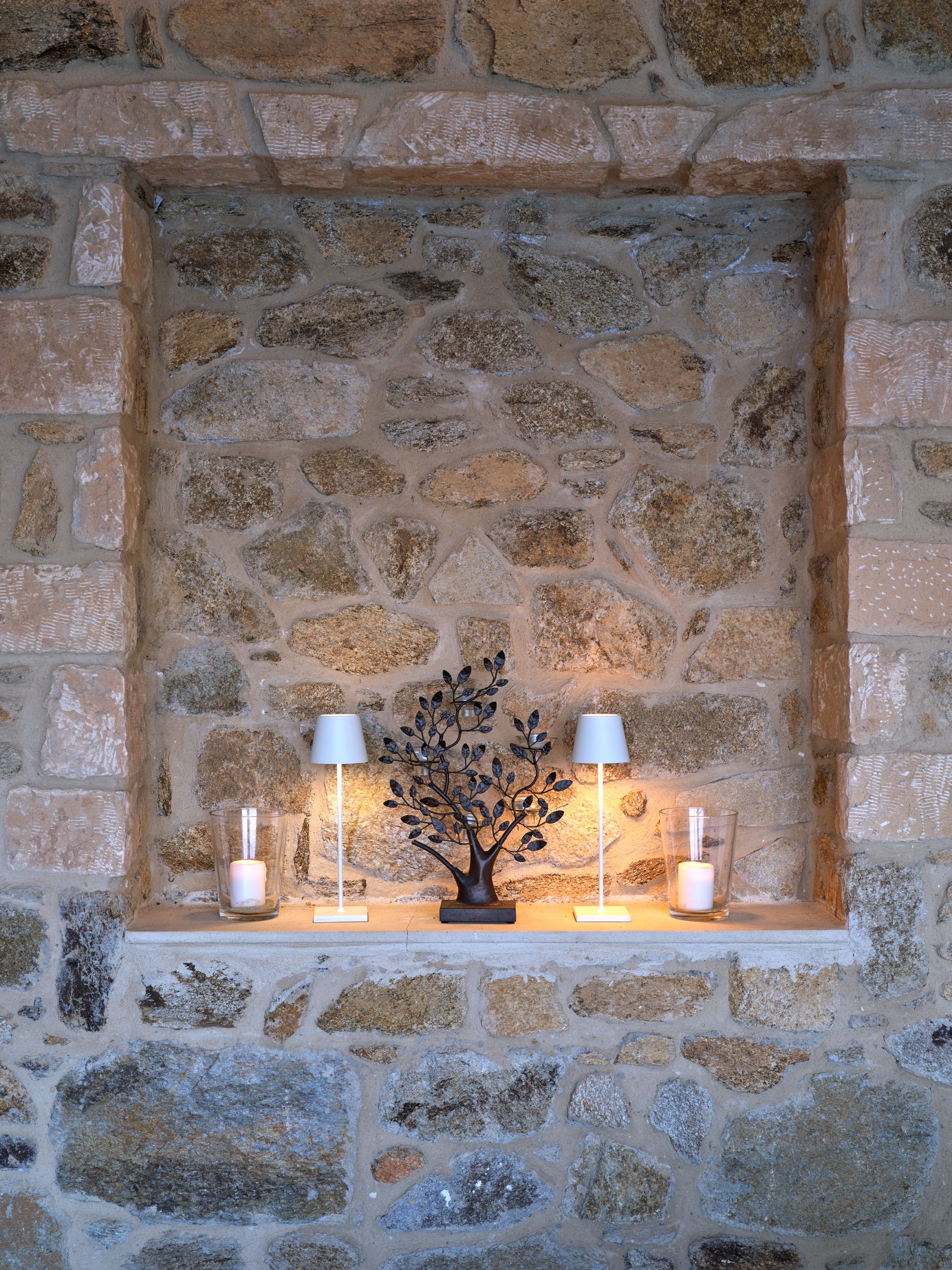 A stone niche with lamps in the living area